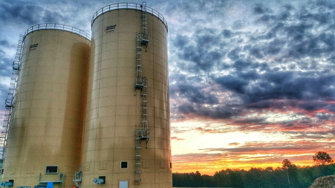 Laidig-branded silos against a sunset background